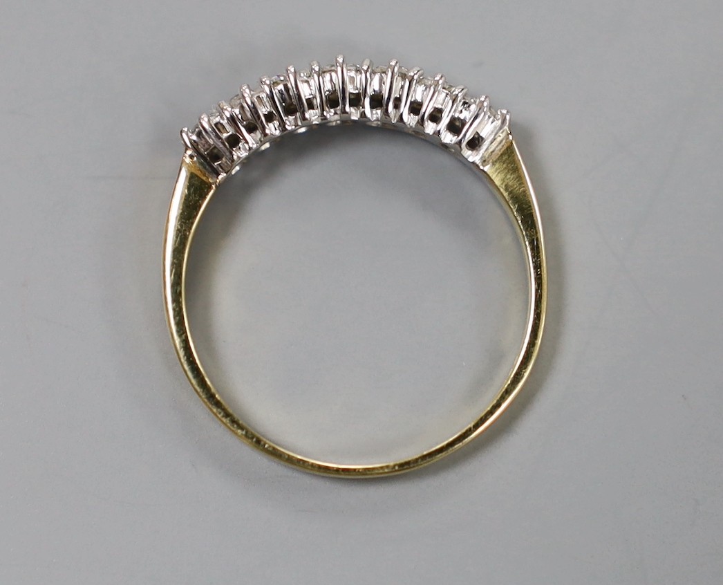 A modern 18ct gold and seven stone diamond set half hoop ring, size P/Q, gross weight 2.6 grams